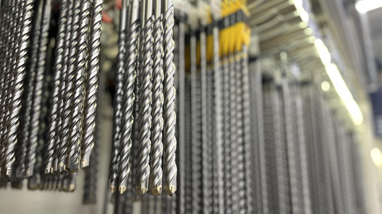 heavy-duty drill bits hanging on display in a hardware store
