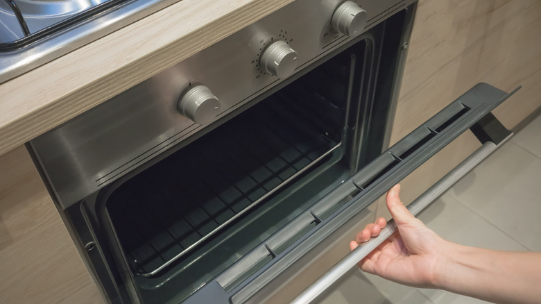 Person opening oven door