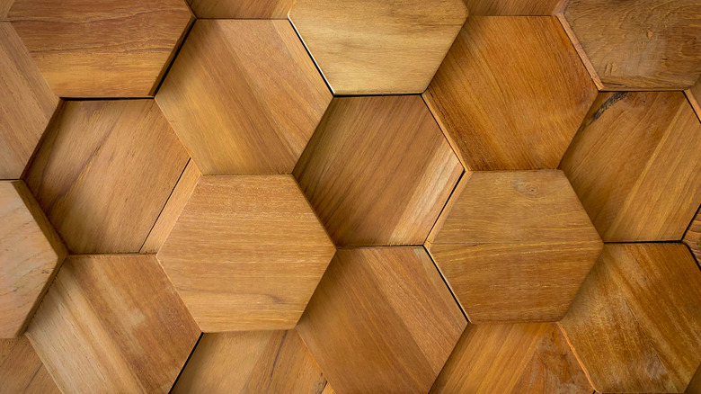 Textured pieces of wood are shown in a honeycomb pattern