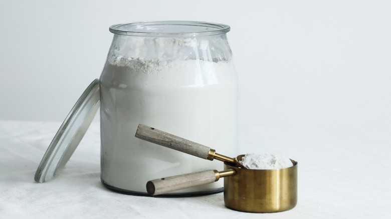 Jar of flour and measuring cup