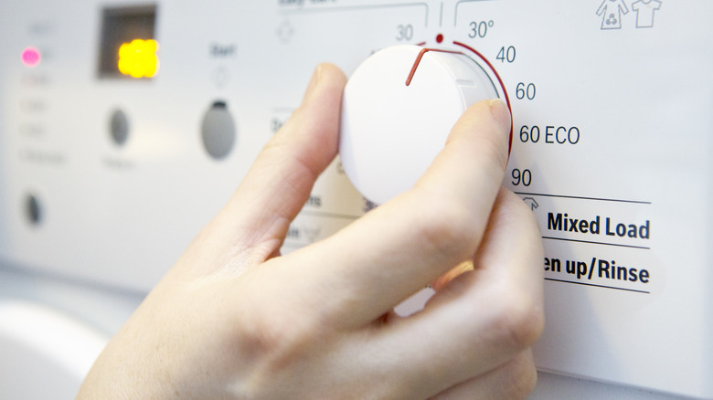 person setting temperature washing machine