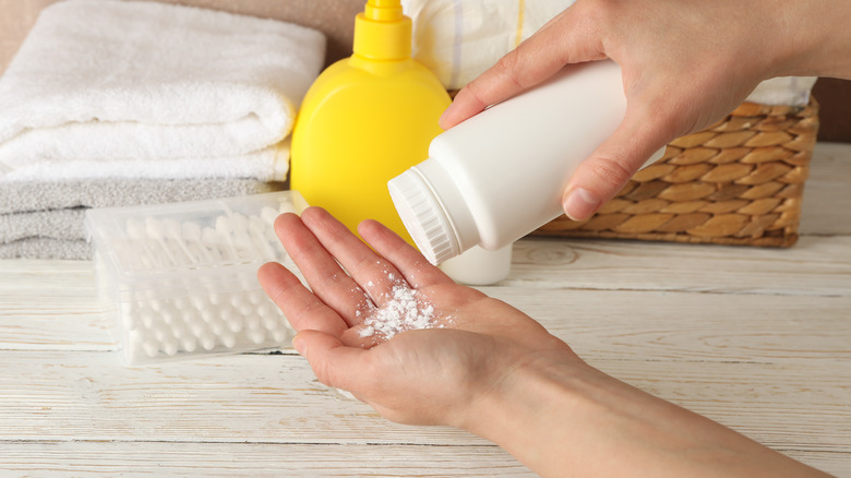 Person sprinkling talcum powder