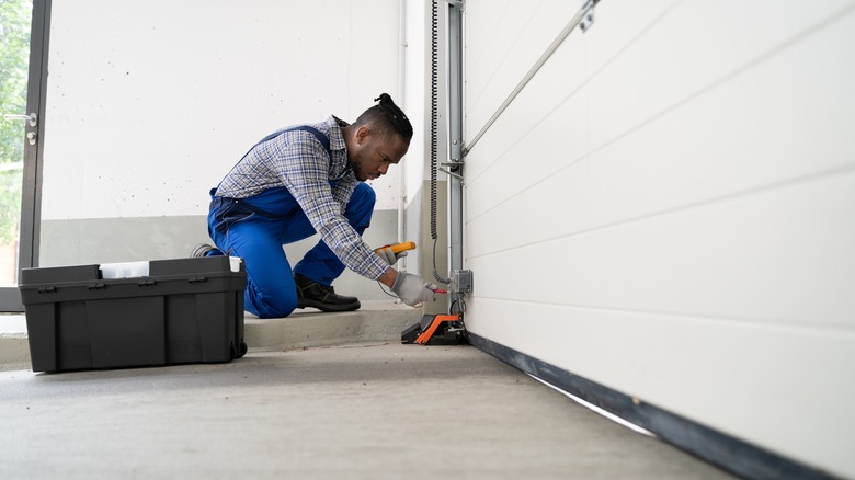 man fixing garage door