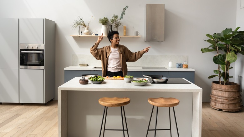 person standing behind kitchen island