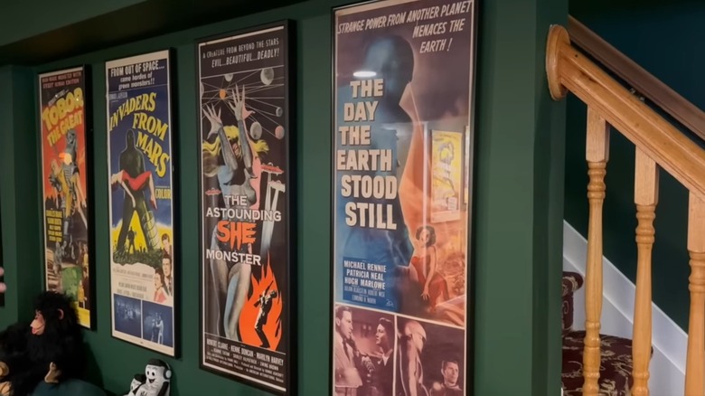 Four framed vintage movie posters on wall