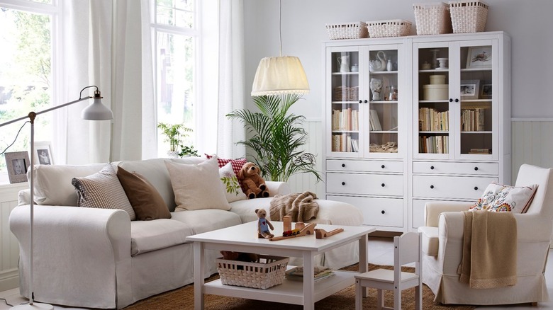 Two white HEMNES Glass-door cabinet in living room