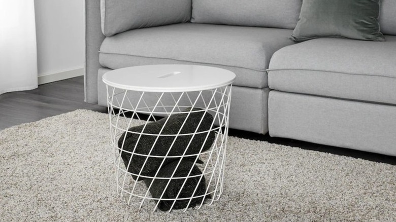 KVISTBRO Storage table in white with blanket rolled up inside in living room