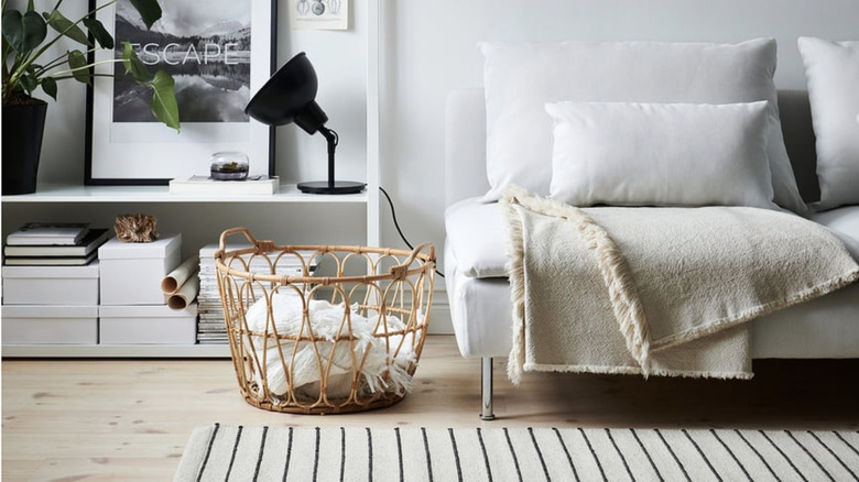 SNIDAD Basket holding a blanket in living room setting