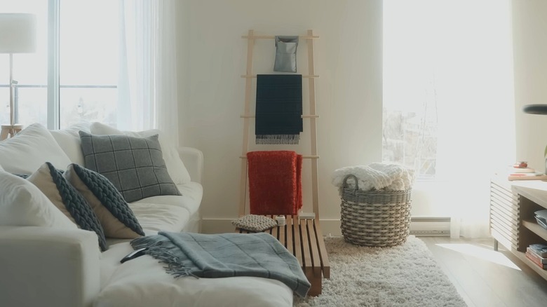 IKEA VILTO towel stand holding a variety of blankets in living room