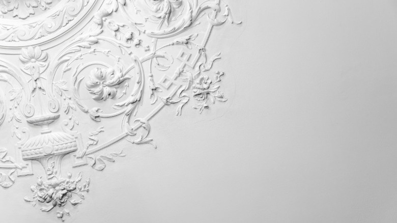 The edge of an ornate pattern on ceiling drywall