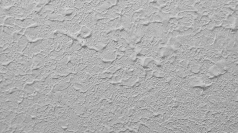 The uneven pits of a stomp brush ceiling