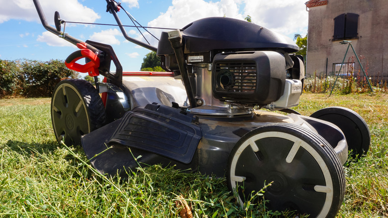 A closeup of a side discharge push lawn mower