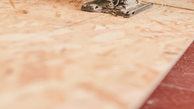 A saw is used to cut a subfloor