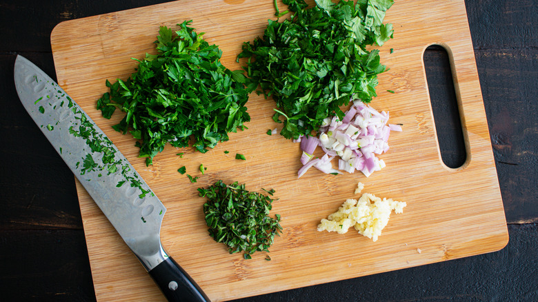 chopped herbs on cutting board