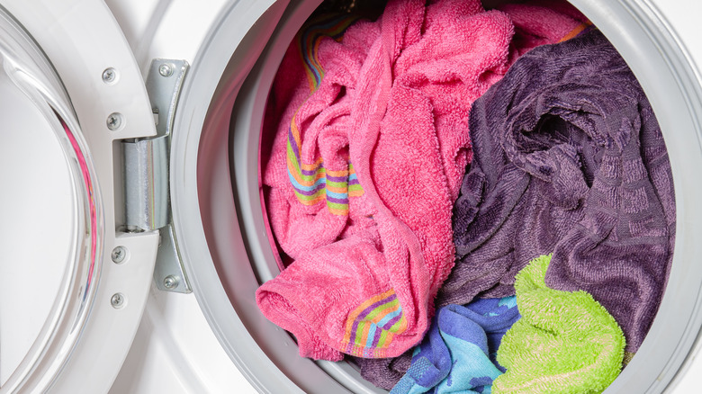 Close-up of full washing machine of colorful linens