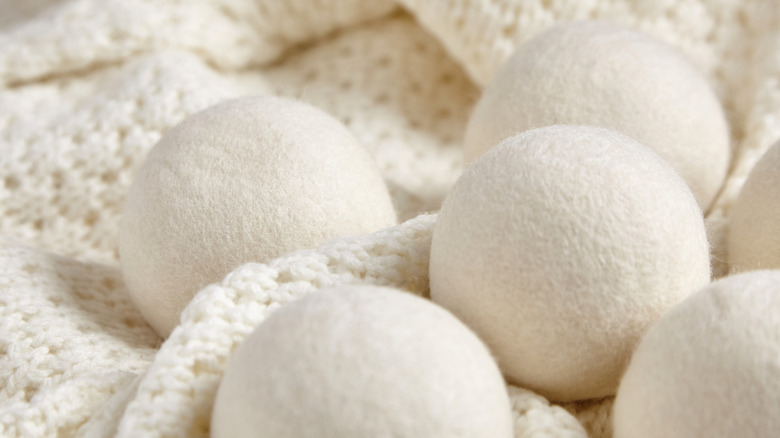 Close up of wool dryer balls resting on a woolen blanket