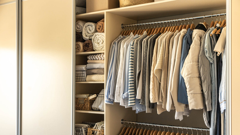 Open closet doors with clothing