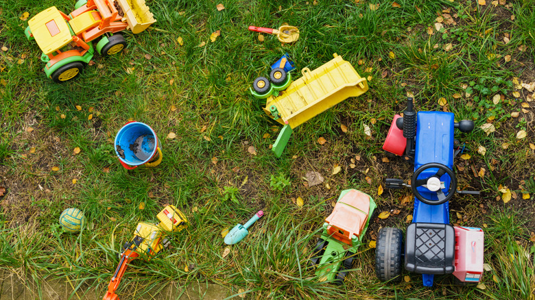 Outdoor children's toys scattered in the grass