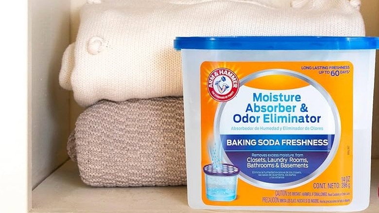 Box of baking soda, some spilled, on an orange background