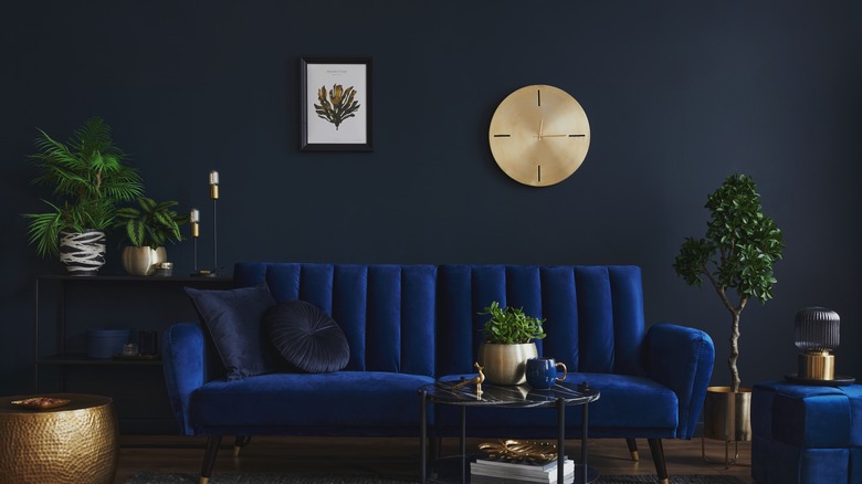 metal clock above sofa