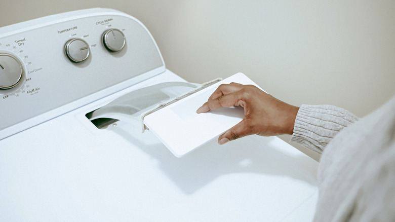 Woman cleaning out dryer lint trap