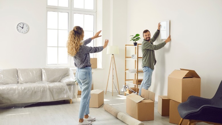 Young couple painting new home 