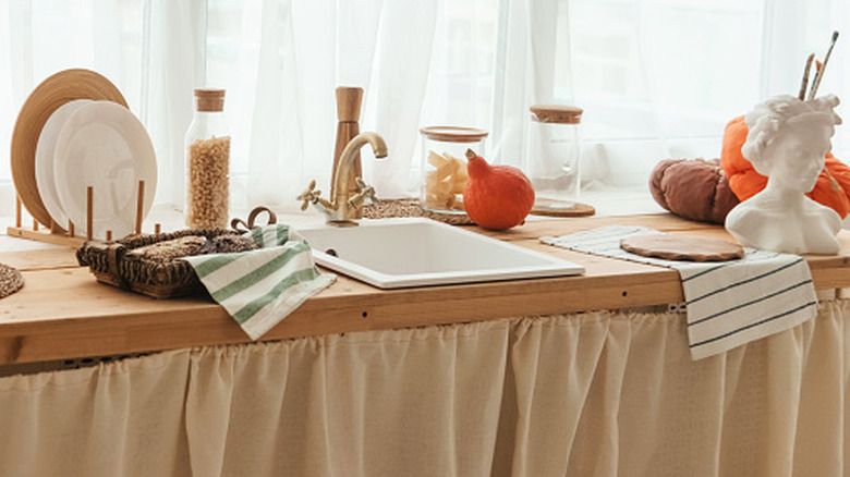 A kitchen with a sink skirt