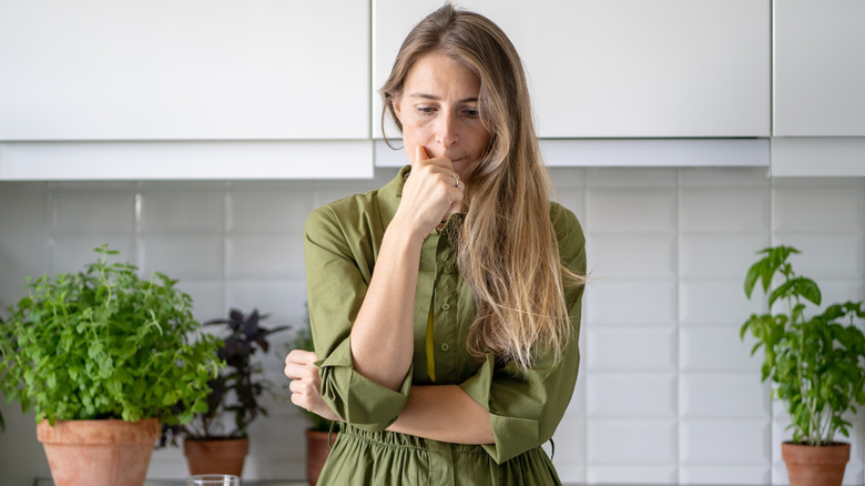 Contemplative woman in kitchen