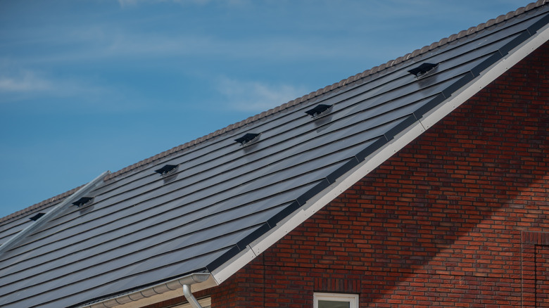 Solar roof tiles on a brick house