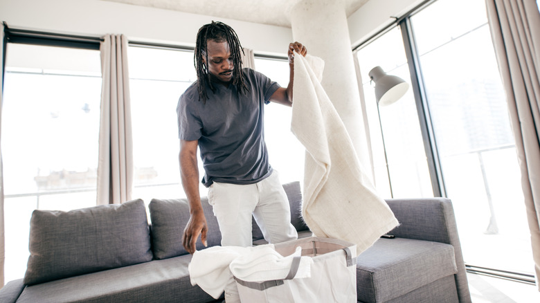 A man organizing his clean laundry.
