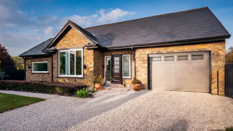 A modern home with a gravel driveway