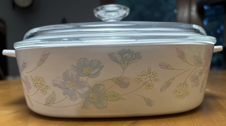 A CorningWare Pastel Bouquet baking dish sitting on a table