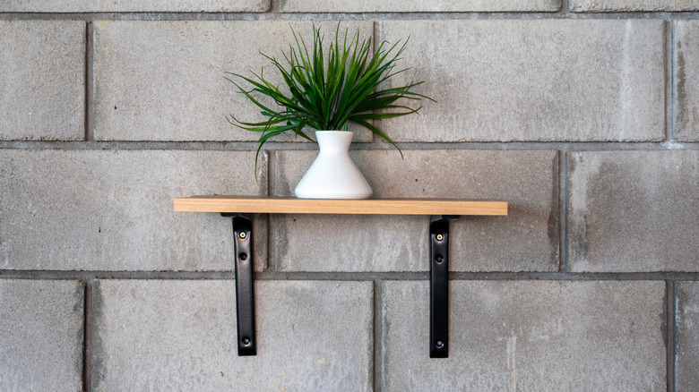 A plain gray cinder block wall