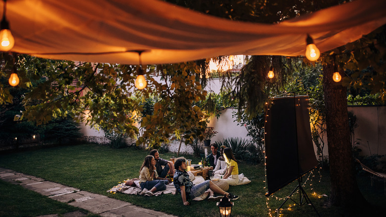 Outdoor lights hanging below a drop cloth