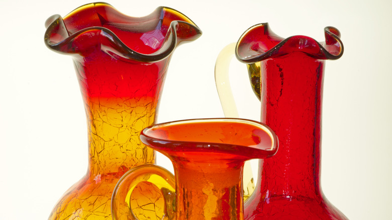 Close up of three blenko red vases