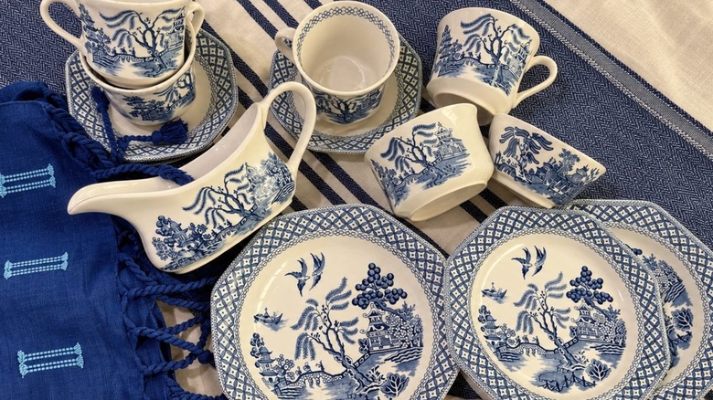 Blue and white Staffordshire china tableware on a tablecloth.