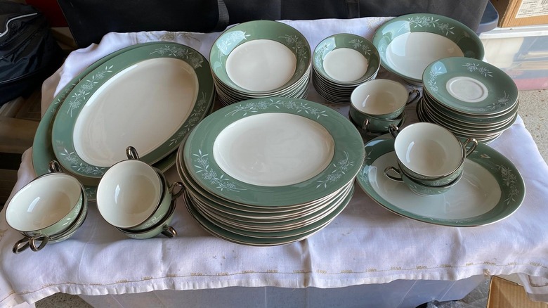 Green and white Syracuse China set with plates, serving dishes, and bowls