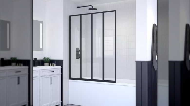 The Triton glass shower panel in a basic white bathroom with black hardware