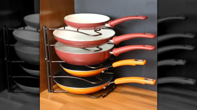 A stack of pans on a vertical Amazon storage rack