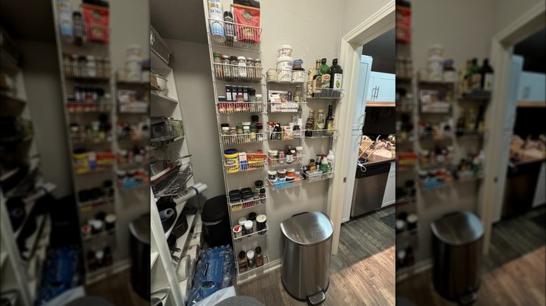 A white rack on wall of a walk-in pantry.