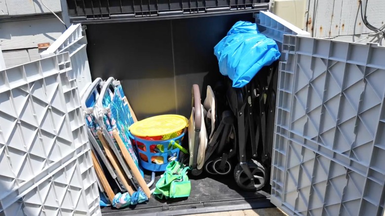 An open plastic garden shed with chairs inside
