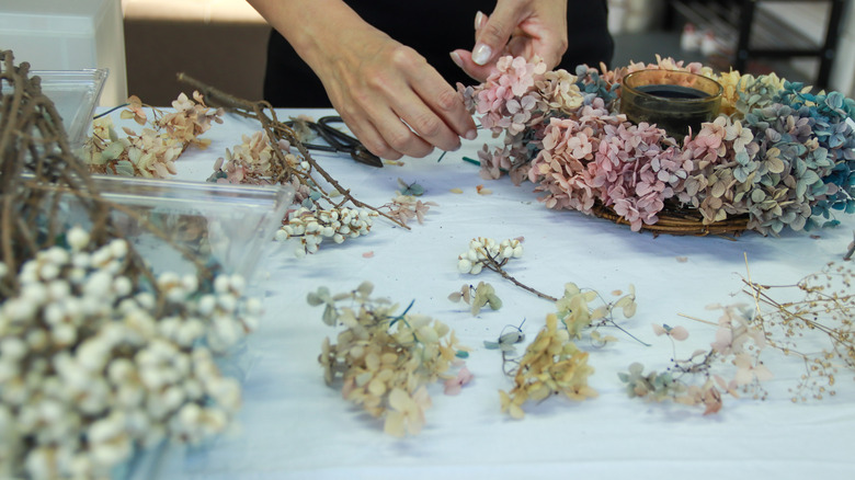 person sorting through dried flowers