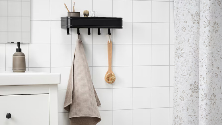 IKEA LILLASJÖN wall shelf on wall with bathroom items on it