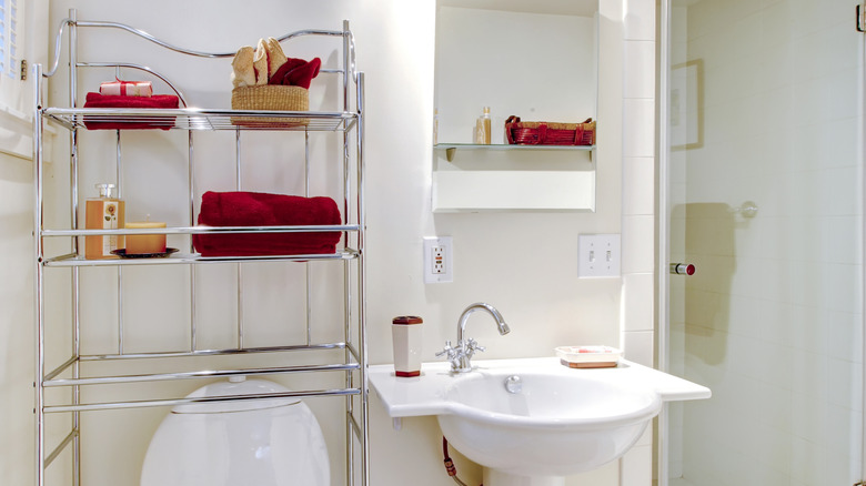 Over-the-toilet shelf above the toilet, next to a bathroom sink