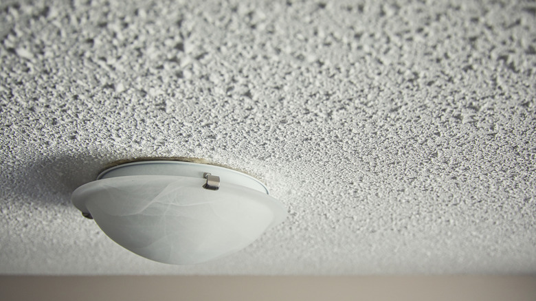 Close up of light on a white popcorn ceiling