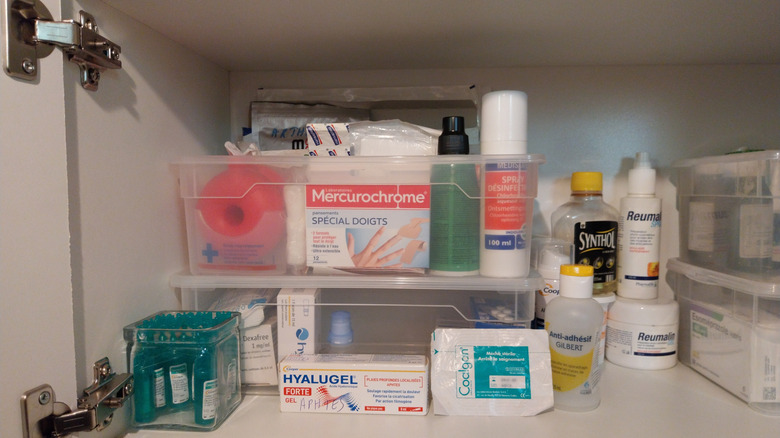 A bathroom medicine cabinet full of medical supplies.