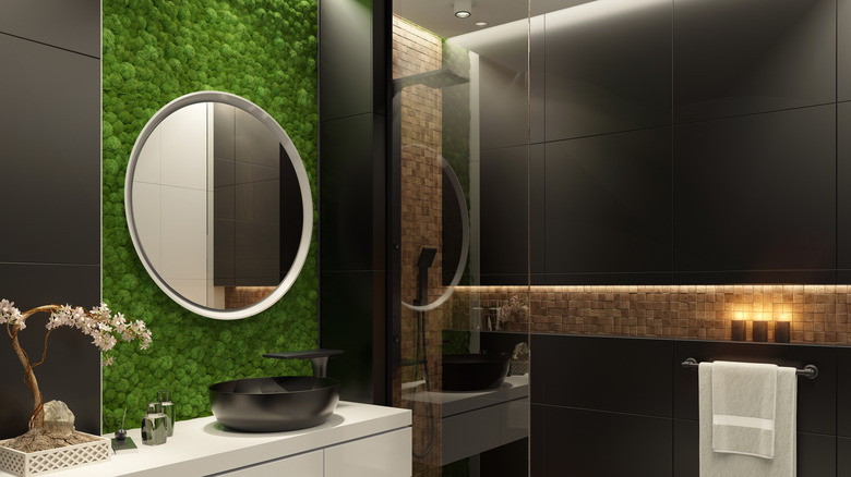 A luxurious bathroom with a moss feature wall.