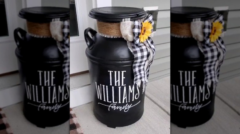 A repurposed vintage metal milk jug with ribbons and flowers