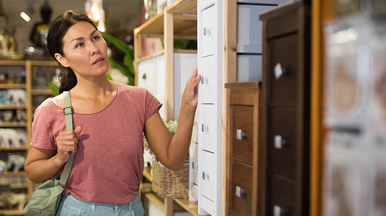 Woman shopping for home storage pieces.