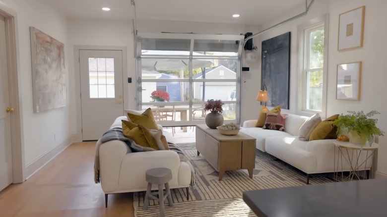 White living room with glass garage door